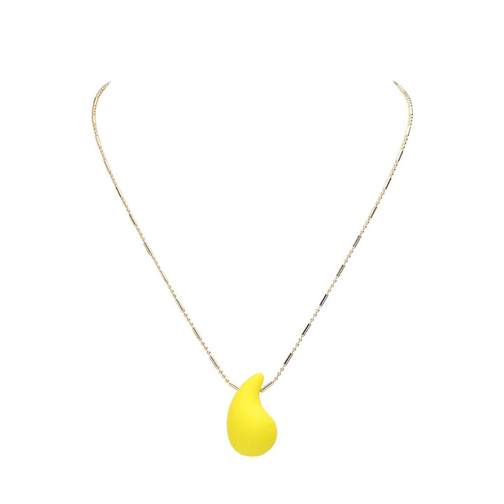 Yellow stunning Matte Colored Teardrop Pendant Necklace is a must-have for any fashion-forward individual. Its matte finish adds a touch of sophistication, while the teardrop shape provides a delicate and feminine touch. Elevate any outfit with this stylish and versatile piece.