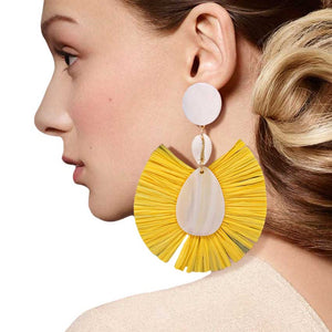 Yellow Puka Shell Mother of Pearl Teardrop Raffia Trimmed Earrings, adorn yourself with these teardrop raffia trimmed earrings! puka shell mother-of-pearl teardrop earrings go perfectly with a t-shirt, summer dress or work clothes, beach party, and many more. 