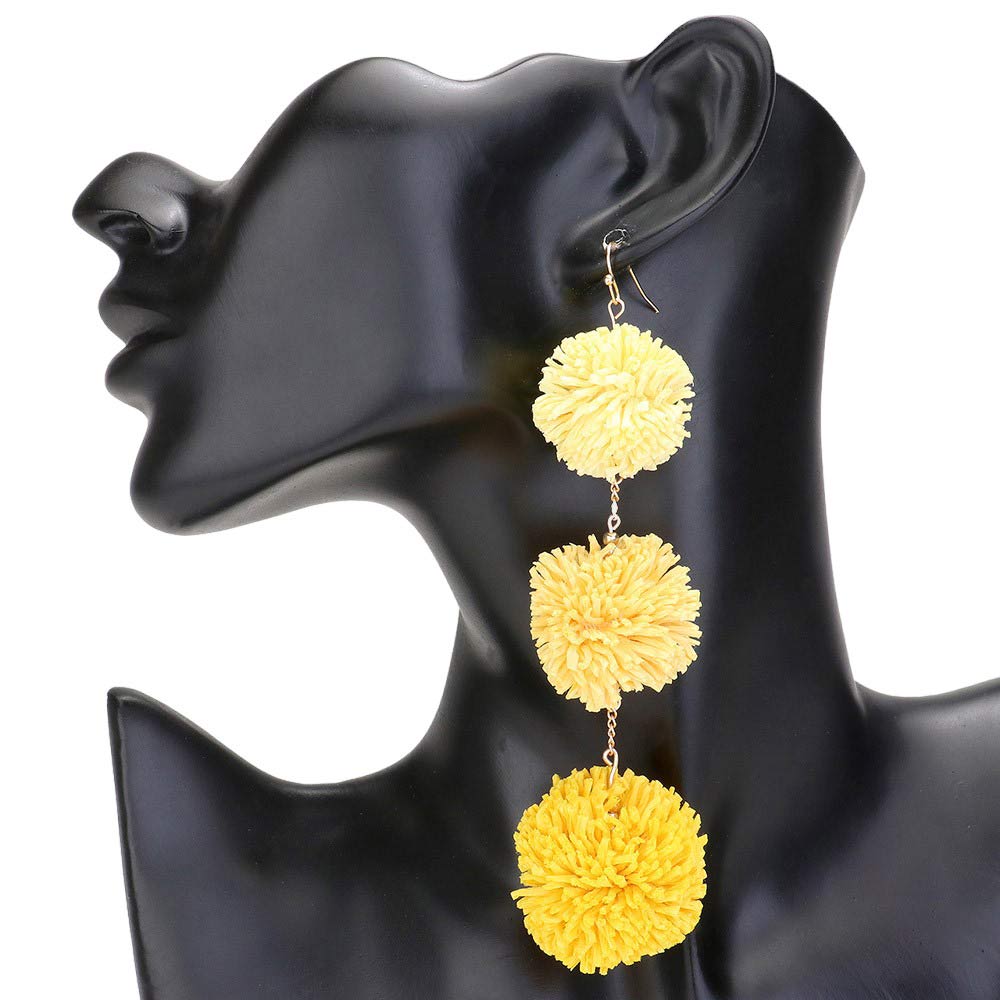 Yellow Raffia Pom Pom Link Dropdown Earrings, These unique earrings combine the natural texture of raffia with playful pom poms to add a touch of whimsy to any outfit. The link design gives them a modern, chic feel while the dropdown style elongates the neck. Elevate your style with these statement earrings.