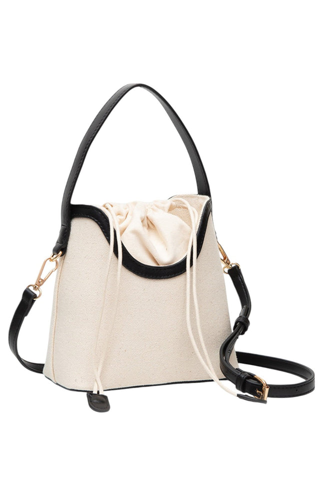 Black Drawstring Satchel Canvas Crossbody Bucket Bag combines durable canvas material with a practical bucket design, secured by a convenient drawstring closure. Its adjustable crossbody strap offers hands-free comfort, making it ideal for daily use or travel. This bag provides ample space for essentials while maintaining a compact, stylish profile suitable for various occasions. 
