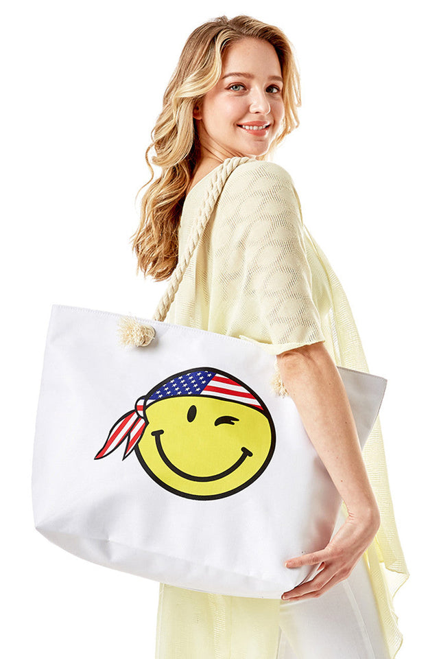 Smiley Face with USA Bandana American Flag Theme Beach Bag features a cheerful smiley face adorned with a USA bandana in an American flag theme, combining patriotic style with practical design. Crafted for durability and spaciousness, it offers ample room for all your beach essentials while making a bold statement. Ideal for summer outings, this bag blends festive flair with everyday functionality. 