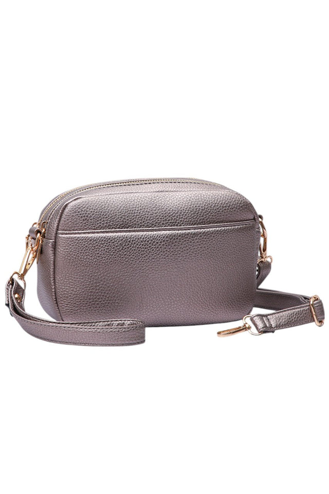 Bronze Two Zipper Solid PU Crossbody Bag combines practical design with durable materials. Crafted from high-quality PU leather, it offers a sleek, solid finish that resists wear. Featuring two separate zippered compartments, it provides organized storage for essentials, making it ideal for daily use or travel. The adjustable crossbody strap ensures comfortable, hands-free carrying, while the minimalist design complements a variety of styles with professional ease. 
