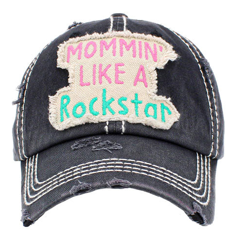 Black Mommin Like A Rockstar Message Vintage Baseball Cap. Fun cool vintage cap perfect for the mommin who is in Charge! Perfect for walks in sun or rain, great for a bad hair day. Soft textured, embroidered message and distressed contrast stitching baseball cap with fun statement will become your favorite cap. Velcro Adjustable Back