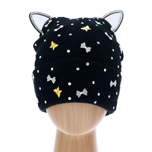 Black Cat Ear Ribbon Stone Embellished Beanie Hat, cat ear ribbon toasty beanie to keep you incredibly warm. It will make you stand out from the crowd. Accessorize the fun way with this stone embellished hat, it's the autumnal touch you need to finish your outfit in style. Perfect to wear at winter parties, prom, graduation, wedding, etc. Awesome winter gift accessory!