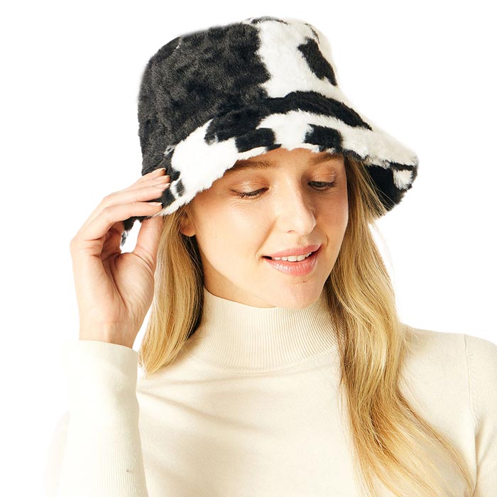 Black Cow Patterned Faux Fur Bucket Hat, this cow patterned bucket hat is nicely designed and a great addition to your attire. Have fun and look stylish anywhere outdoors. Great for covering up when you are having a bad hair day. Perfect for protecting you from the wind, snow, beach, pool, camping, or any outdoor activities in cold weather. Amps up your outlook with confidence with this trendy bucket hat. Perfect gift for Birthdays, Christmas, Stocking stuffers, Secret Santa, holidays, etc.