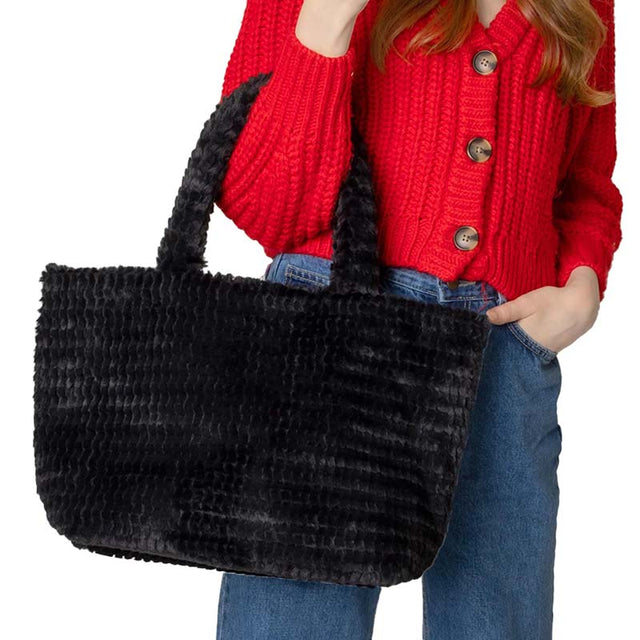 Black Fuzzy Fur Tote Bag, is a cute and beautiful mini tote bag that enriches your accessory collection and amps up your outlook with beautiful color variations. It perfectly goes with any outfit in any style. Easy to carry and keep your handy items safe and secure. Nice color variation gives you the opportunity to match the tote up with any ensemble, any time, and anywhere. An excellent gift for your near and dear ones. Have a cute look with this fuzzy fur tote!