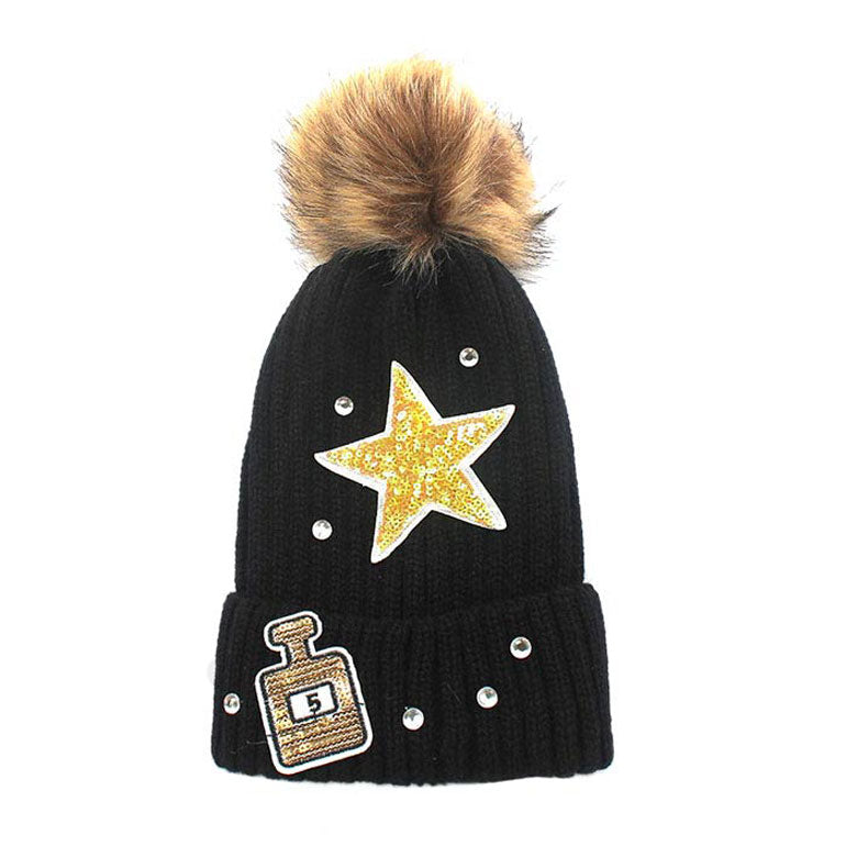 Black Sequin Perfume Star Patch Beanie Hat With Pom Pom. Accessorize the fun way with this faux fur pom star patch Beanie. The autumnal touch you need to finish your outfit in style. These Beanie made with warm acrylic and nylon yarn to ensure maximum comfort and durability. Ideal winter head cover! Comes in one size winter cap with a pom that fits most head sizes. Absolutely the perfect gift winter accessory!