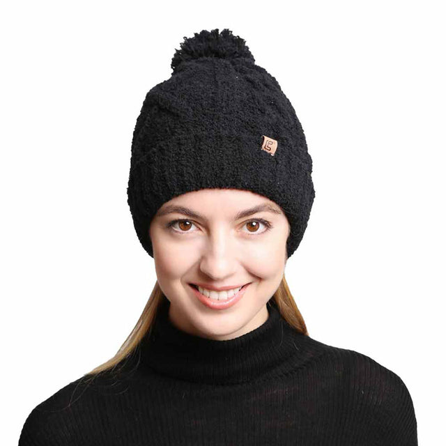 Black Solid Color Cable Knit Beanie. Accessorize the fun way with this pom cable knit Beanie. The autumnal touch you need to finish your outfit in style. Cable knit Beanie made with warm poly microfiber to ensure maximum comfort and durability. Ideal winter head cover! Comes in one size winter cap with a pom that fits most head sizes. Absolutely the perfect gift winter accessory!