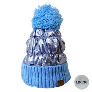 Blue Puffer Knit Pom Pom Glossy Winter Cozy Beanie Hat. Before running out the door into the cool air, you’ll want to reach for this toasty beanie to keep you incredibly warm. Accessorize the fun way with this puffer knit pom pom hat, it's the autumnal touch you need to finish your outfit in style. Awesome winter gift accessory!