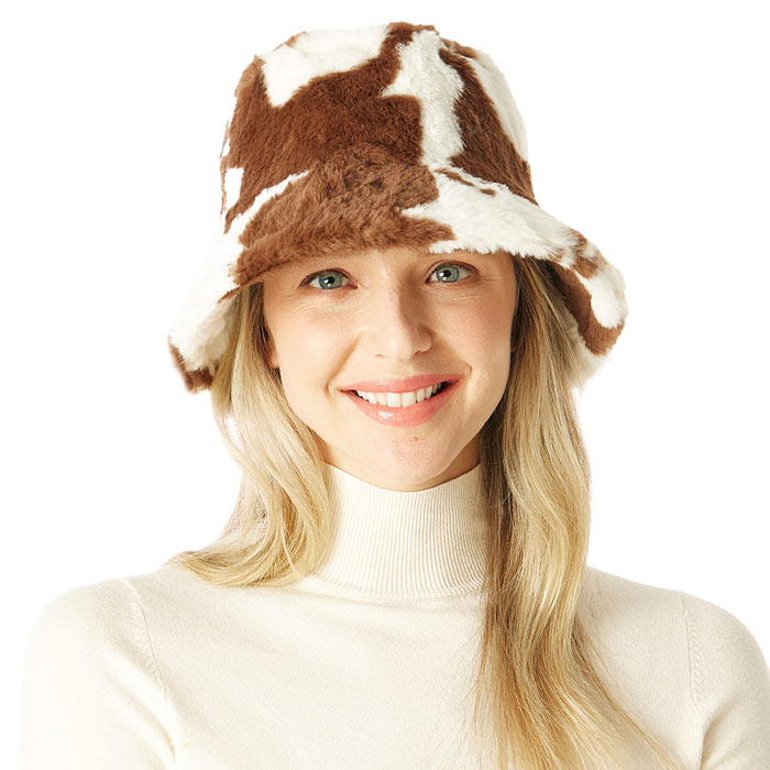 Brown Cow Patterned Faux Fur Bucket Hat, this cow patterned bucket hat is nicely designed and a great addition to your attire. Have fun and look stylish anywhere outdoors. Great for covering up when you are having a bad hair day. Perfect for protecting you from the wind, snow, beach, pool, camping, or any outdoor activities in cold weather. Amps up your outlook with confidence with this trendy bucket hat. Perfect gift for Birthdays, Christmas, Stocking stuffers, Secret Santa, holidays, etc.