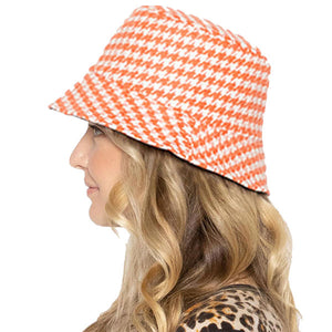 Coral Polyester Houndstooth Patterned Bucket Hat, this bucket hat doubles as a rain hat and is snug on the head and stays on well. It will work well to keep the rain off the head and out of the eyes and also the back of the neck. Wear it to lend a modern liveliness above a raincoat on trans-seasonal days in the city.