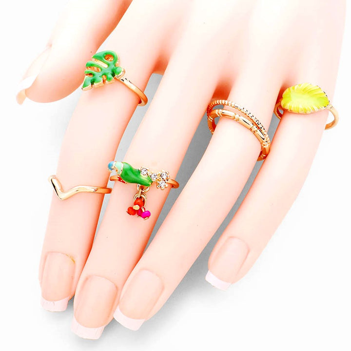 6pc Set Crystal Embellished Parrot, Enamel Tropical Leaf, Metal Rings, add a sweet treat to your look, this set of rings will show your tropical and fruity side ideal for any summer get together and embrace the beauty of nature and add the perfect pop of detail to your look. • Color: Gold • Theme : Animal, Flower/Leaf, Fruits/Food • Size : 0.1" H - 0.6" H