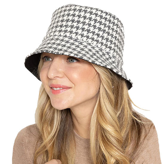 Gray Polyester Houndstooth Patterned Bucket Hat, this bucket hat doubles as a rain hat and is snug on the head and stays on well. It will work well to keep the rain off the head and out of the eyes and also the back of the neck. Wear it to lend a modern liveliness above a raincoat on trans-seasonal days in the city.