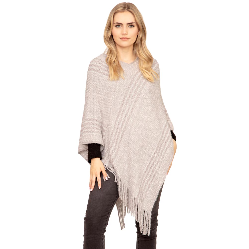Gray Striped Knit Tassel Poncho, is the perfect accessory that amps up your confidence with perfect beauty adding the right amount of luxe to your ensemble. It's a luxurious, trendy, super soft chic capelet that keeps you warm and toasty on cold days and winter. From stylish layering camis to relaxed tees, you can throw it on over so many pieces elevating any casual outfit!
