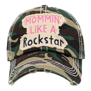 Green Mommin Like A Rockstar Message Vintage Baseball Cap. Fun cool vintage cap perfect for the mommin who is in Charge! Perfect for walks in sun or rain, great for a bad hair day. Soft textured, embroidered message and distressed contrast stitching baseball cap with fun statement will become your favorite cap. Velcro Adjustable Back