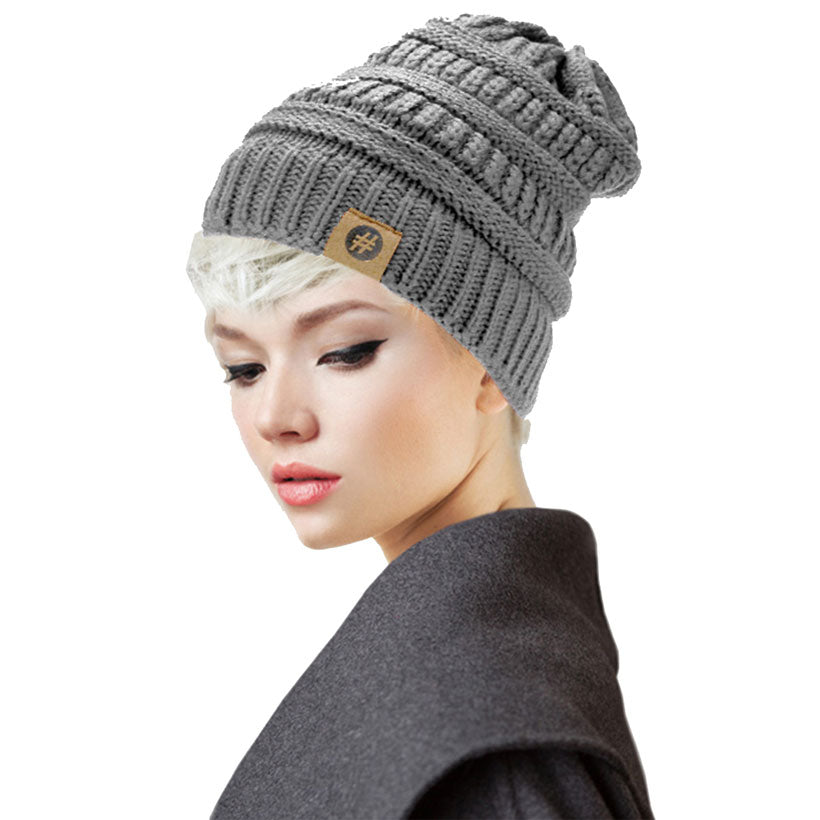 Grey Acrylic Solid Knitted Hashtag Beanie Hat. Before running out the door into the cool air, you’ll want to reach for these toasty beanie to keep your hands incredibly warm. Accessorize the fun way with these beanie, it's the autumnal touch you need to finish your outfit in style. Awesome winter gift accessory!