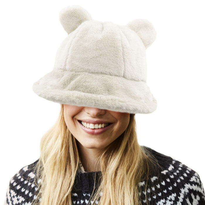 Ivory Faux Fur Bear Ear Bucket Hat, Show your excellent choice with this chic Faux Fur bear Bucket Hat. This animal themed bucket hat is nicely designed and a great addition to your attire. Have fun and look Stylish anywhere outdoors. Great for covering up when you are having a bad hair day. Perfect for protecting you from the wind, snow, beach, pool, camping, or any outdoor activities in cold weather. Amps up your outlook with confidence with this trendy bucket hat. 
