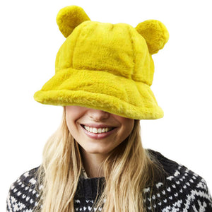 Mustard Faux Fur Bear Ear Bucket Hat, Show your excellent choice with this chic Faux Fur bear Bucket Hat. This animal themed bucket hat is nicely designed and a great addition to your attire. Have fun and look Stylish anywhere outdoors. Great for covering up when you are having a bad hair day. Perfect for protecting you from the wind, snow, beach, pool, camping, or any outdoor activities in cold weather. Amps up your outlook with confidence with this trendy bucket hat. 