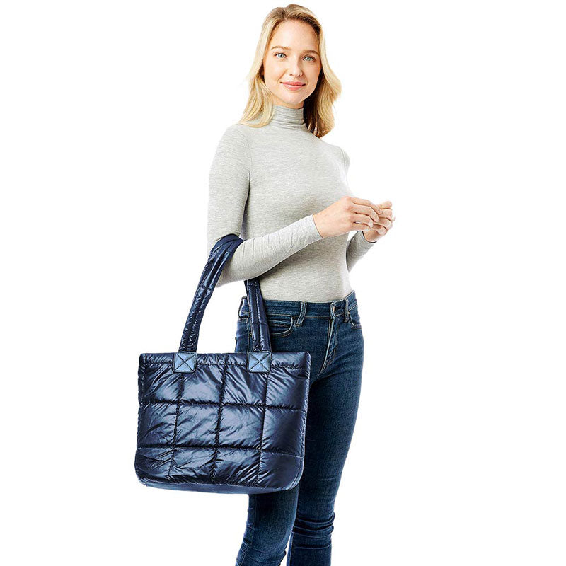 Navy Quilted Shiny Puffer Tote Bag, has plenty of room to carry all your handy items with ease. This handbag features a top zipper closure for security that makes your life easier and trendier. Its catchy and awesome appurtenance drags everyone's attraction to you. Perfect gift ideas for a Birthday, Holiday, Christmas, Anniversary, Valentine's Day, etc. Great for different activities including quick getaways, long weekends, picnics, beach, or even going to the gym! 