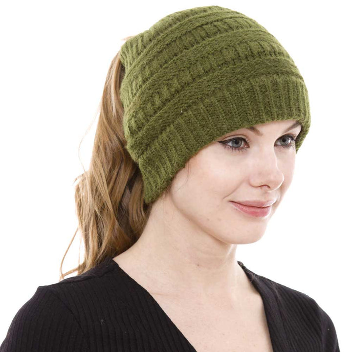 Olive Green Cable Knit Ponytail Beanie Hat, Perfect for pulling your messy bun or high ponytail, while keeping ears warm. Great to wear while exercising in cold weather to keep your hair up and your head warm. It's the autumnal touch you need to finish your outfit in style. The cable knit hat can be used on your working day, You can also wear it in outdoor sports: running, biking etc. Awesome winter gift accessory!