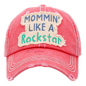 Pink Mommin Like A Rockstar Message Vintage Baseball Cap. Fun cool vintage cap perfect for the mommin who is in Charge! Perfect for walks in sun or rain, great for a bad hair day. Soft textured, embroidered message and distressed contrast stitching baseball cap with fun statement will become your favorite cap. Velcro Adjustable Back