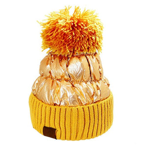 Gold Puffer Knit Pom Pom Glossy Winter Cozy Beanie Hat. Before running out the door into the cool air, you’ll want to reach for this toasty beanie to keep you incredibly warm. Accessorize the fun way with this puffer knit hat, it's the autumnal touch you need to finish your outfit in style. Awesome winter gift accessory!