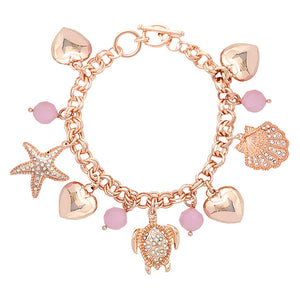 Rose Gold Rhinestone Embellished Starfish Turtle Shell Toggle Bracelet. This sea-themed bracelet features a parade of marine creatures for a fun, beachy vibe. With a polished finish and lifelike details. A timeless and traditional Holiday, Anniversary gift, Birthday gift, Valentine's Day gift for a woman or girl of any age.